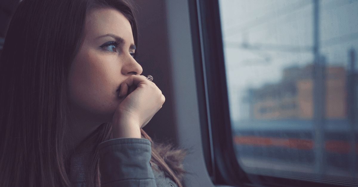 A woman sits alone on a train looking out the window. The only one who cares about you is you.