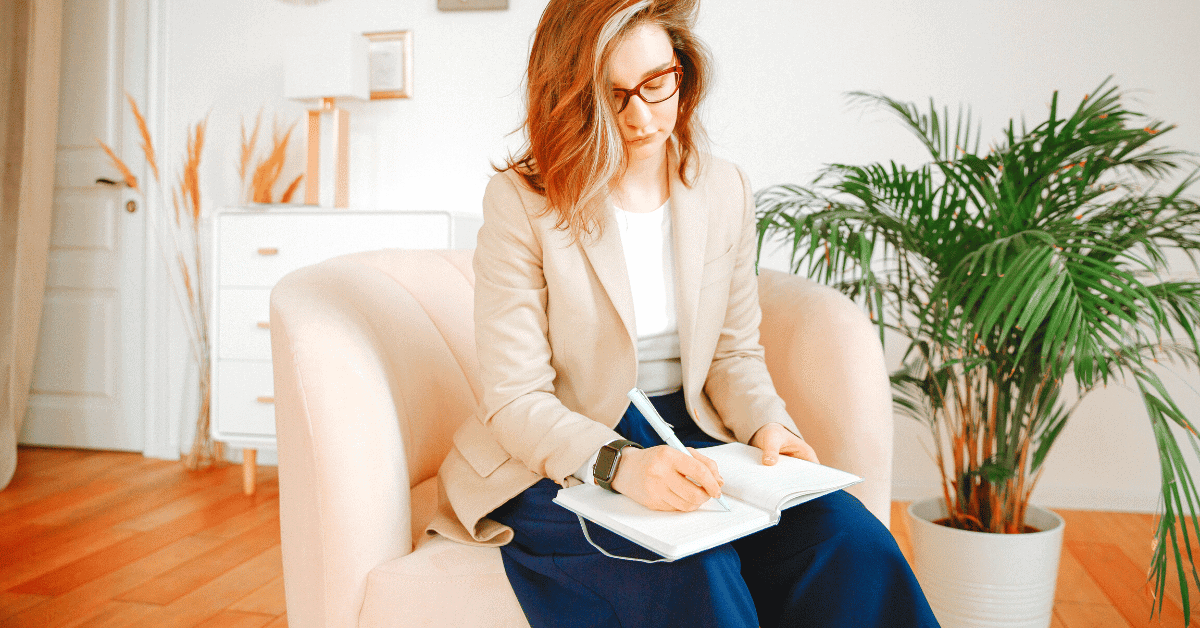 A therapist is sitting down writing notes
